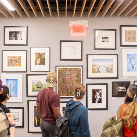 Students looking at art in the hallway